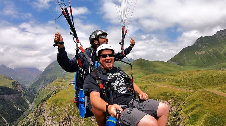 Tim is all smiles on his tandem paraglide in Kazbegi, Georgia