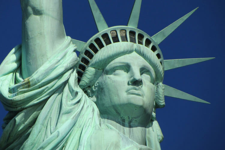 A close up of Lady Liberty's face and crown with it's seven rays