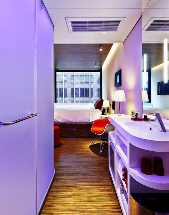 The room at citizenM with purple mood lighting on