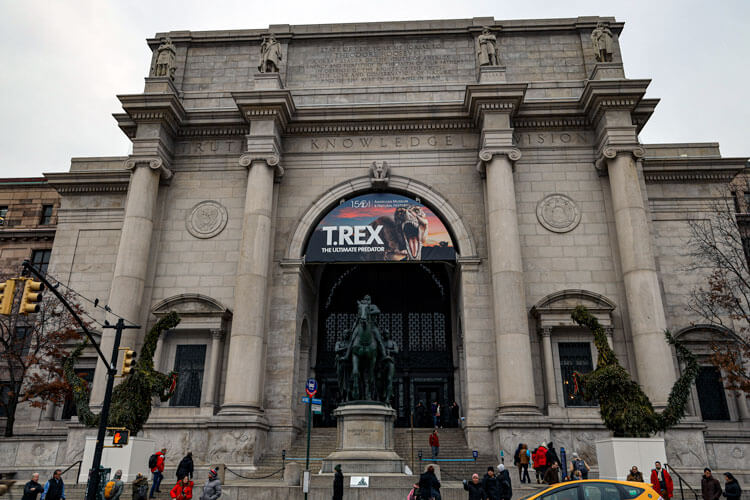 The exterior of the American Museum of Natural History with the Teddy Roosevelt statue in the center of the entry