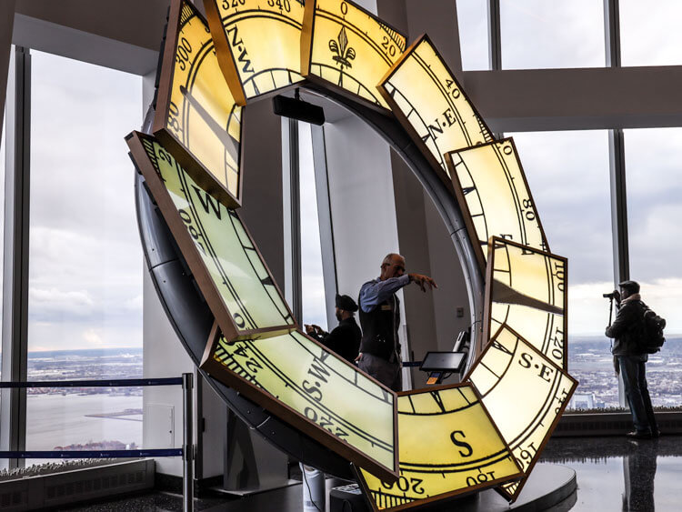 A tourism ambassador gives a brief orientation of NYC  with a multimedia digital compass at One World Observatory