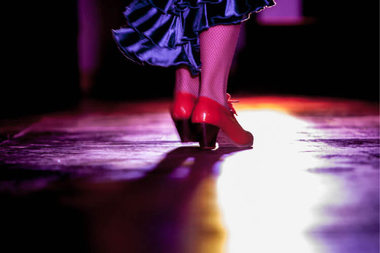 A close up of a flamenco dancer's red shoes 