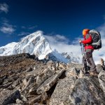 A woman stops to admire a snowy Nepal peak on a climbing expedition
