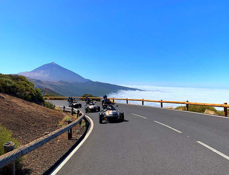 The group from the Can Am Spyder tour on a curve of the road with Mount Teide high above in the background in Tenerife