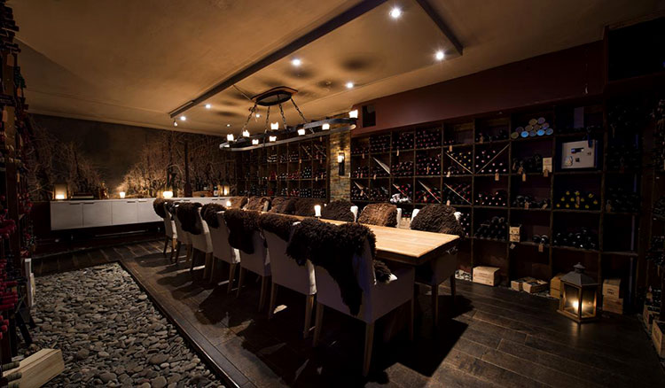 The wine cellar at Huset with a long table for private dinners or wine tasting in the center 