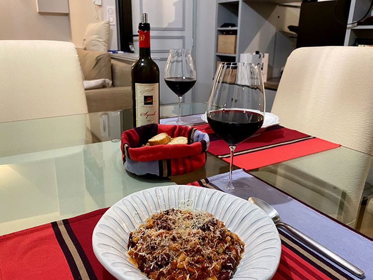 Our table set with two pasta bowls of pasta fagioli and Maremma Syrah wine