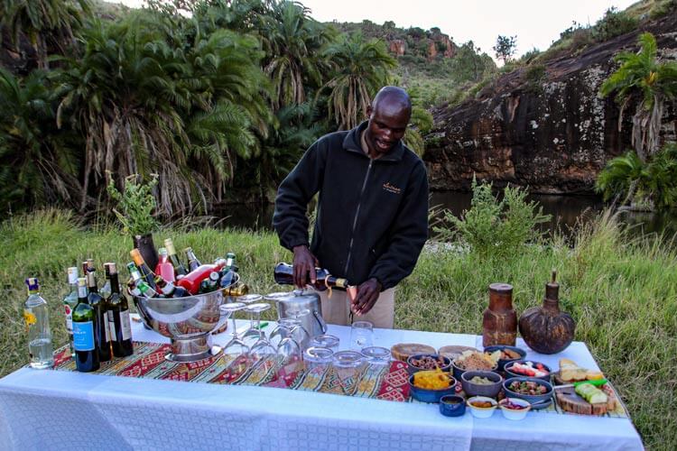 An Elewana Collection employee pours Amarula at the sundowner bar in Loisaba Conservancy