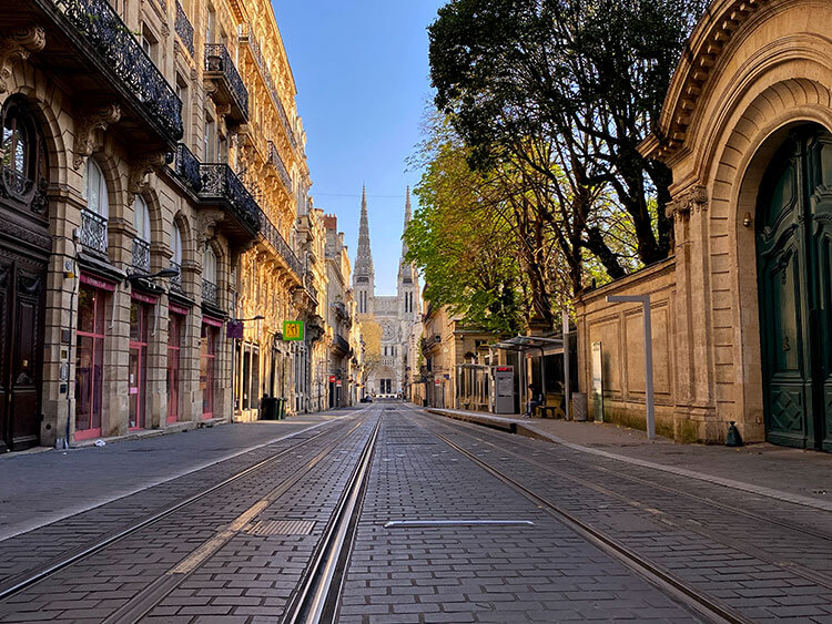 An empty Rue Vital Carles with the Bordeaux Cathedral visible at the end of the street in Bordeaux, France