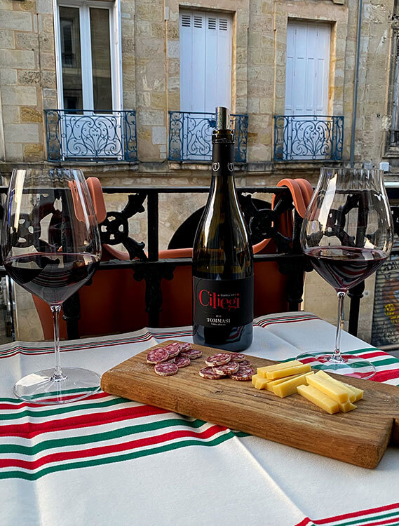 Our window apéro with a bottle of Italian wine, saucisson and cheese in Bordeaux, France