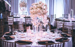 Pink and white rose centerpiece on table in wedding venue