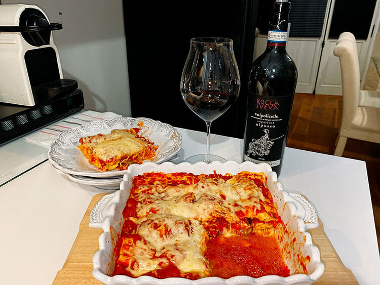 Rustic Sausage Lasagna in the baking pan with one piece plated