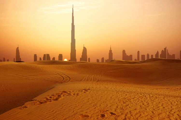 Dubai, United Arab Emirates at sunset with the skyline seen from the desert