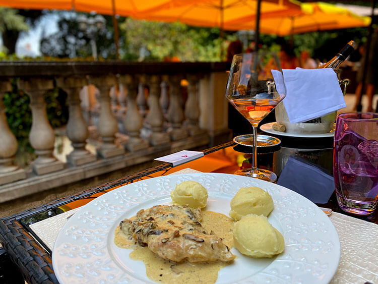 A Limoges porcelain dish with chicken and mushroom cream and mashed potatoes served on the terrace at Le Coq en Pâte in Guéret