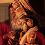 Kathakali performers dressed up in elaborate costumes