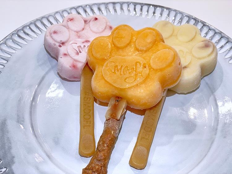 A variety of three different homemade paw shaped pupsicles