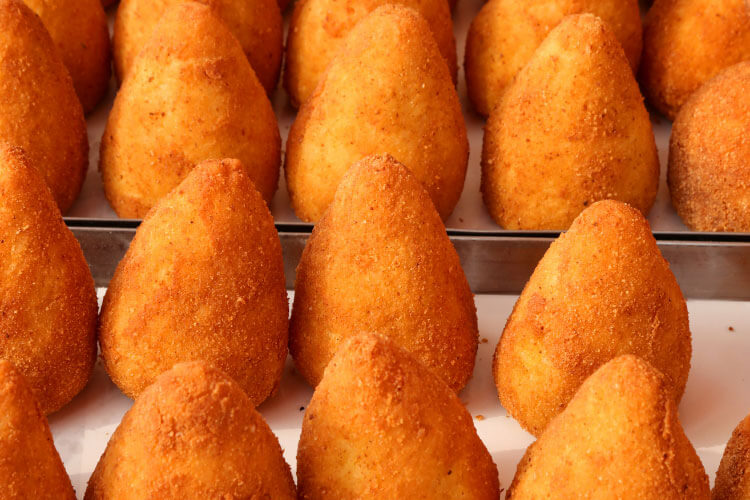 Arancini in a case at a shop in Catania, Sicily