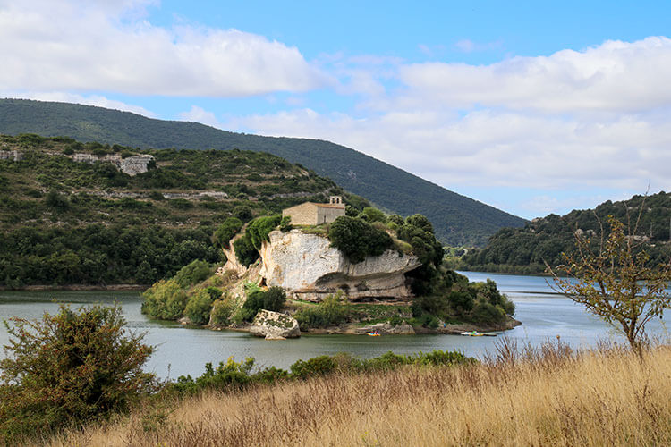 A panoramic view over Lago San Sebastiano with its island and medieval church atop the island in Isili, Sardinia
