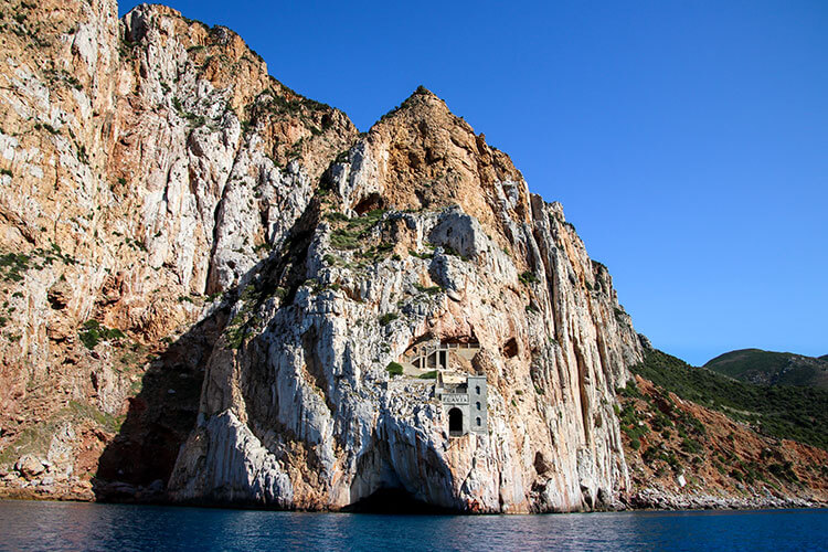 The mine of Porto Flavia cut right into a mountain rising up from the sea in Sardinia