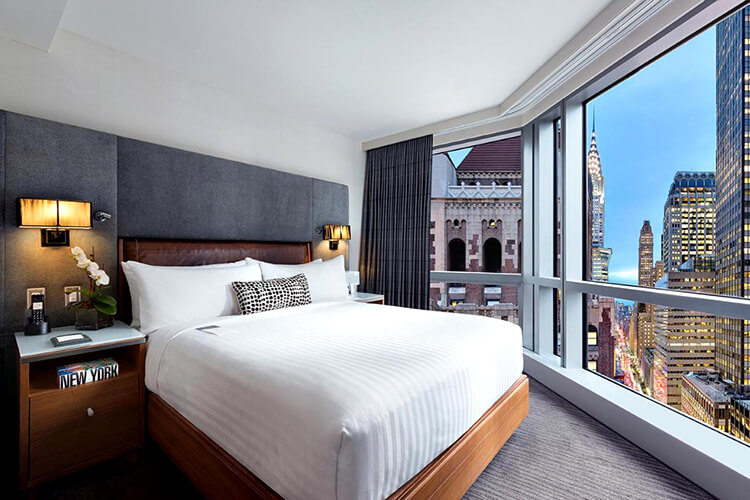 A hotel room at Hotel 48LEX with floor to ceiling window and Chrysler Building view in New York City