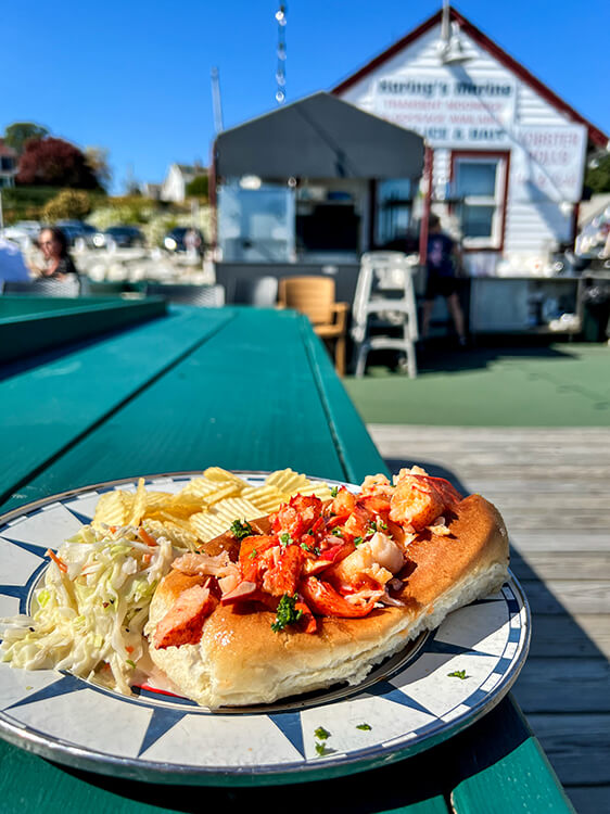 A Connecticut-style lobster roll at Ford's Lobster served with coleslaw and potato chips in Noank, Connecticut