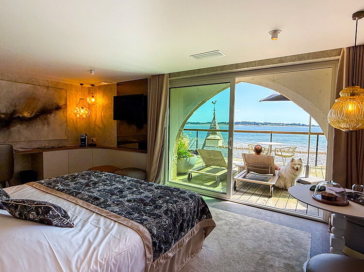 Our room in Manoir Renaissance with a terrace and sea view. Coco sits on the terrace