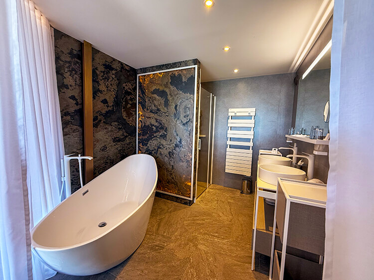 The Coiffes room with both a soaking tub and a rain walk-in shower, along with double sinks 