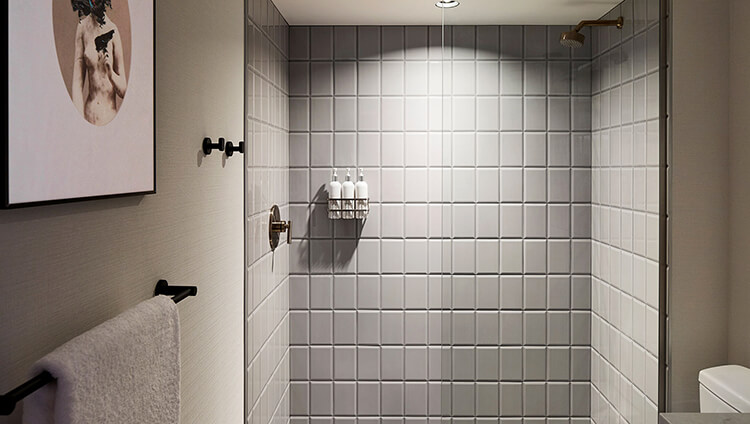 A walk-in shower in the guest bathroom at Kimpton Saint George Toronto