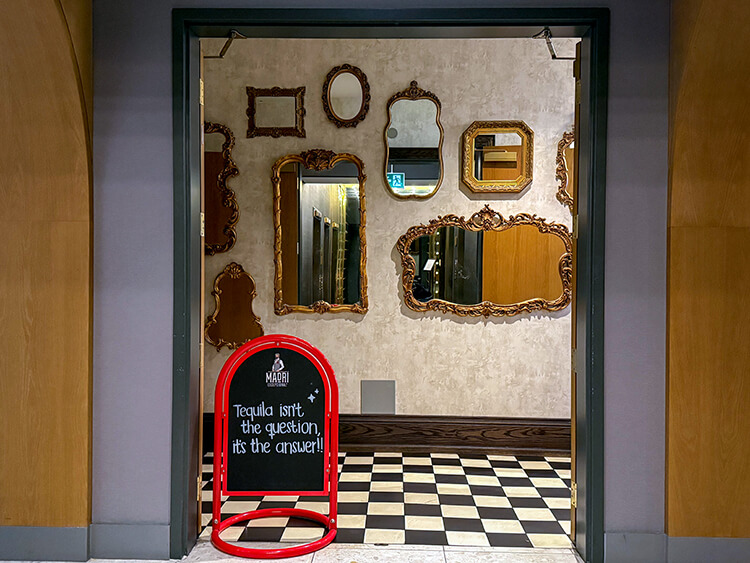 A gallery wall of mirrors at the hotel entrance to the onsite restaurant the Fortunate Fox at the Kimpton Saint George