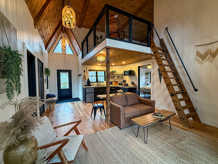 The central living room in Jubliee with open-style kitchen and loft