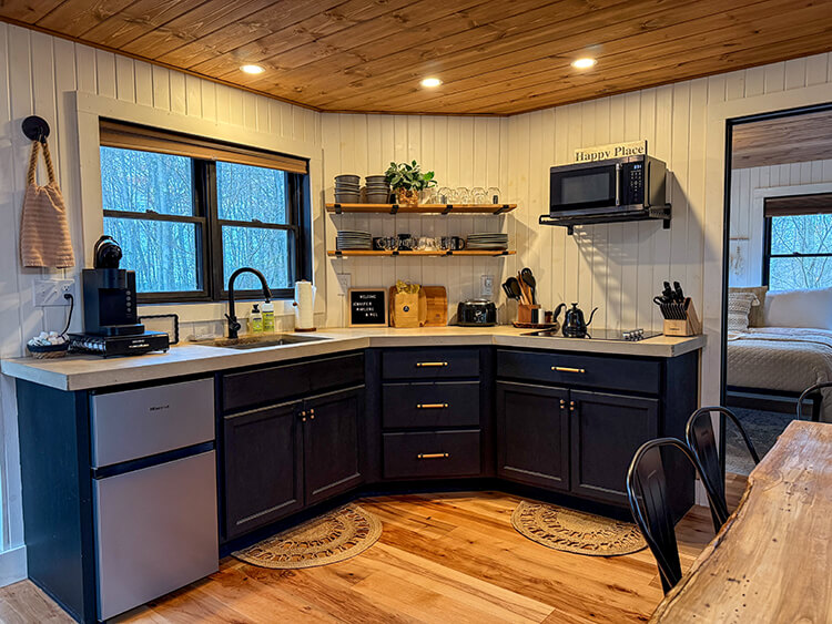 The kitchen is well equipped with stovetop, microwave, Keurig, and refrigerator