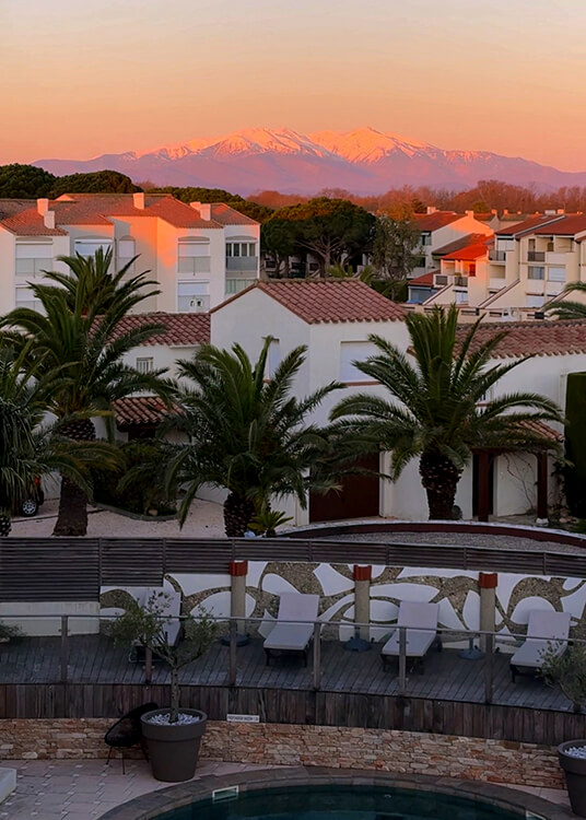 View to the mountains at sunrise from our balcony at Hotel L'Île de la Lagune