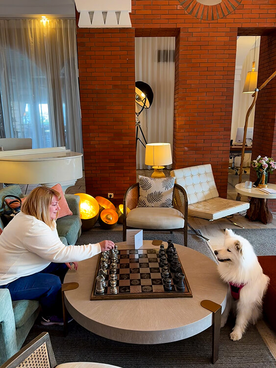 Jennifer and Coco play chess in the lobby at Hotel L'Île de la Lagune in Saint-Cyprien, France