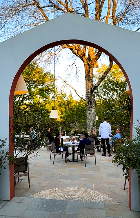 The garden terrace of the gourmet restaurant at Les Frères Ibarboure with lights suspended from oak trees