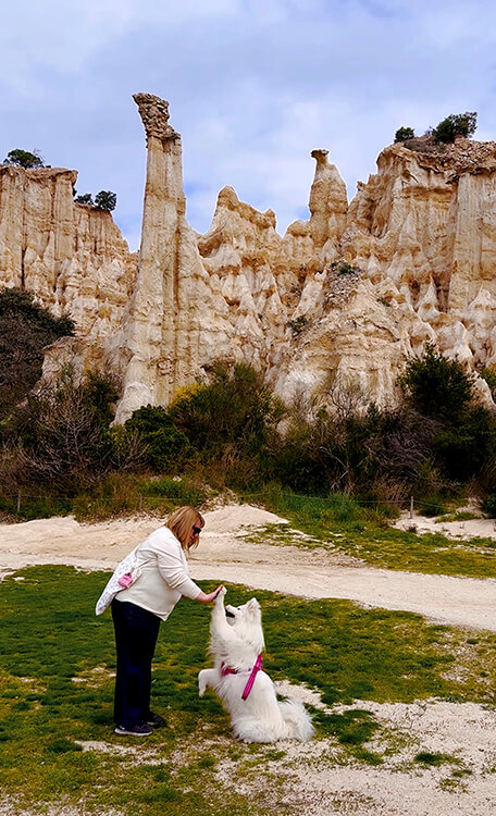 Jennifer and Coco high five in front of the fairy chimneys of Les Orgues d'Ille-sur-Têt