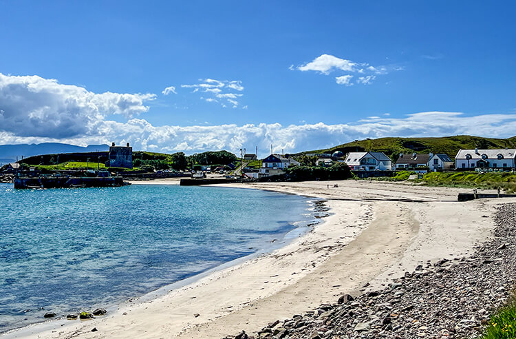 A view of Calre Island's Beach with Granuaile’s Castle above the harbor