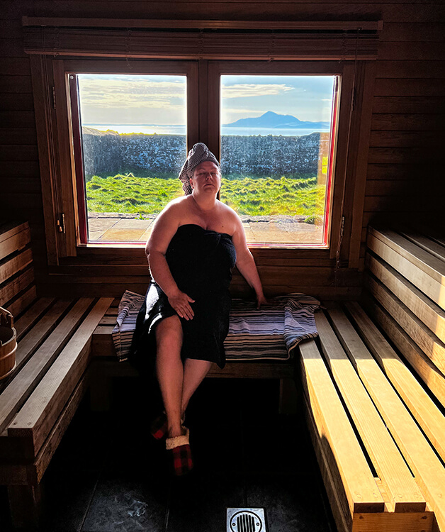 Jennifer in a towel enjoying the sauna in the Sauna Suite at Clare Island Lighthouse