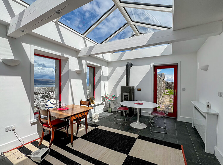 The conservatory with floor to ceiling windows and a greenhouse glass roof with sea views at Clare Island Lighthouse