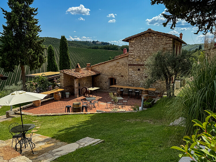 The main reception building with outdoor bar and terrace overlooking the vineyards at Querceto di Castellina